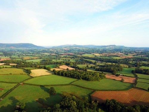 Ariel view of central Monmouthshire landscape, looking towards the Brecon Beacons