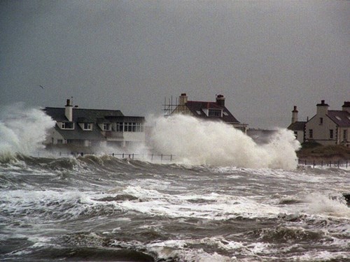 Houses by the coastline during a storm at Trearddur Bay, Anglesey