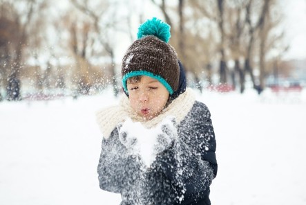 child plays in snow